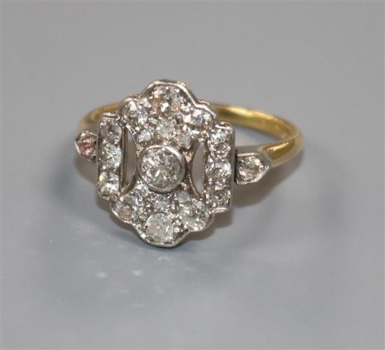 An Art Deco 18ct gold, platinum and diamond cluster ring, size M.